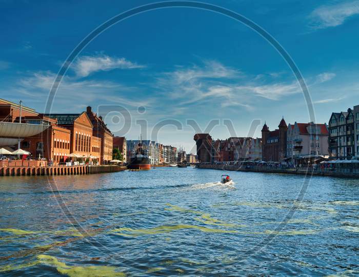 Gdansk, North Poland - August 13, 2020: Panoramic View Of Summer In Motlawa River Adjacent To Beautiful European Architecture Near Baltic Sea During Covid 19 Pandemic Against Blue Sky