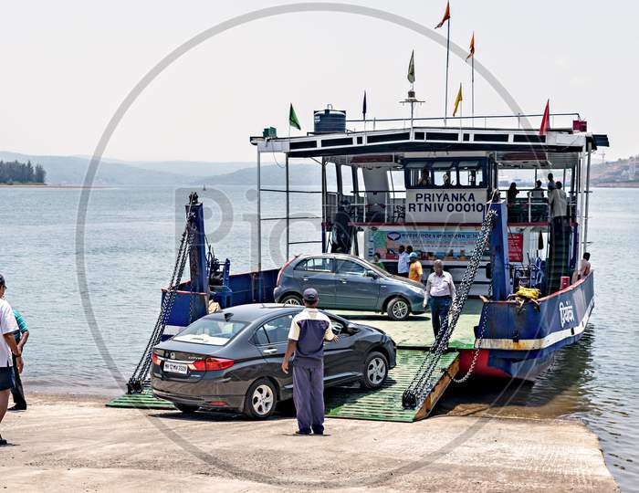 Vehicles Being Loaded In Ferry Boat At Jaygad To Cross The Creek.