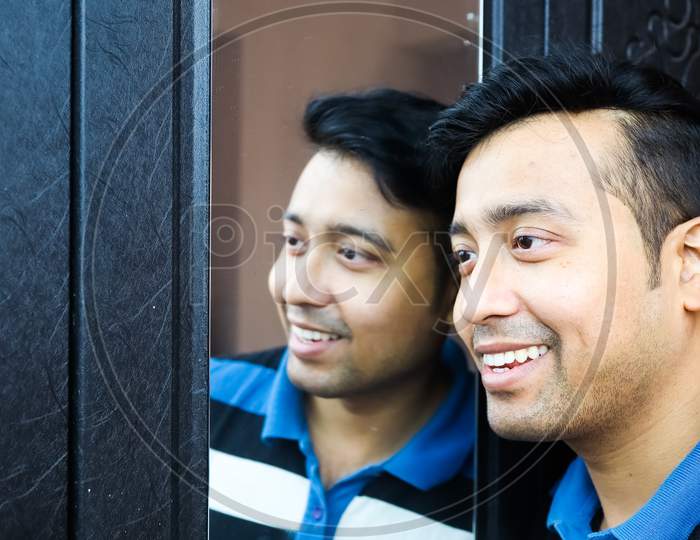 A Man I And His Reflection In Mirror Smiling In Happy Mood