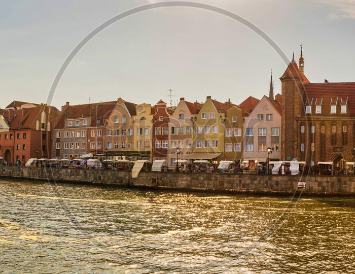 Gdansk, North Poland - August 13, 2020: Sunset Panoramic View Of Summer Around Motlawa River Adjacent To Beautiful Polish Architecture Near Baltic Sea And Ship Docked On Left