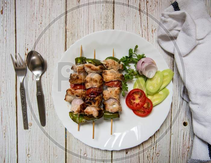 Grilled vegetables with chicken kebabs top view
