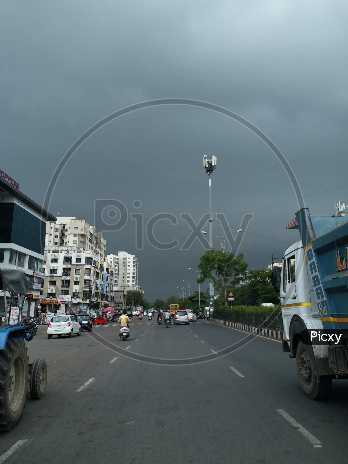 Cityscape Road View With Black Rain Clouds Before Rain Is Coming Over Urban Building.