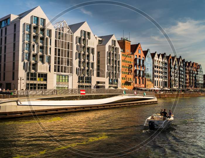 Gdansk, North Poland - August 13, 2020: People Riding Motor Boat In Summer In Motlawa River Adjacent To Polish Architecture Next To Baltic Sea During Covid 19 Pandemic