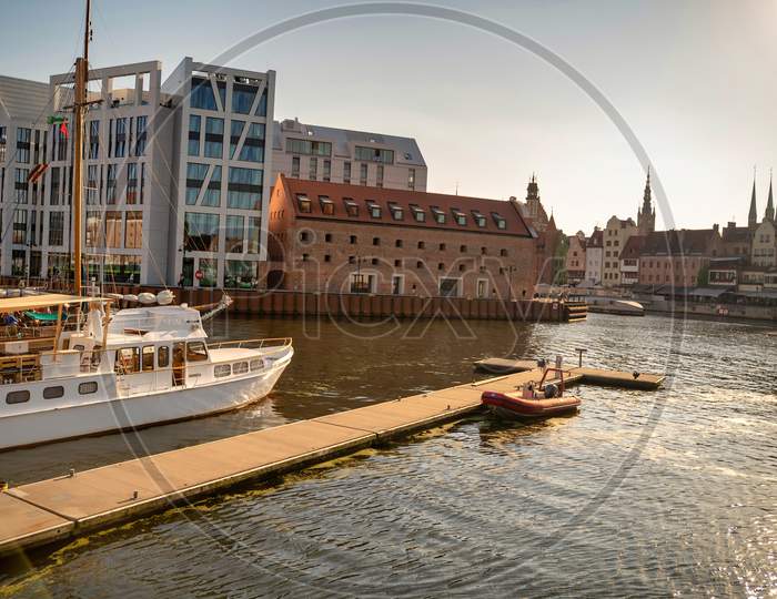 Gdansk, North Poland - August 13, 2020: Sunset Panoramic View Of Summer Around Motlawa River Adjacent To Beautiful Polish Architecture Near Baltic Sea And Motor Boats Docked