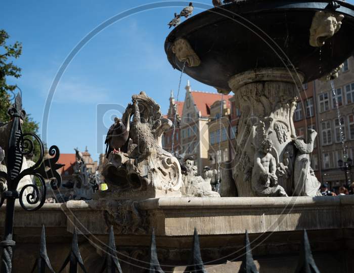 Gdansk, North Poland - August 13, 2020: Close Up Rear Shot Of A Most Touristic Attraction Neptune'S Fountain Located In City Center Main Square