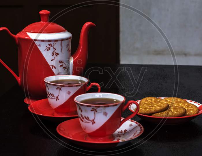 Ceramic Teapot Cup Of Tea And Plates And Biscuits
