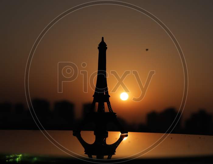 Eiffel Tower In Paris At Sunrise & Sunset. Small Eiffel Tower With Sun.