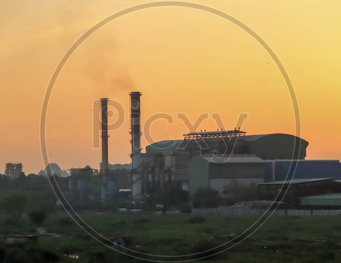 Factory Pipe Polluting Air, Smoke From Chimneys Against Sun, Environmental Problems, Ecological Theme, Industry Scene