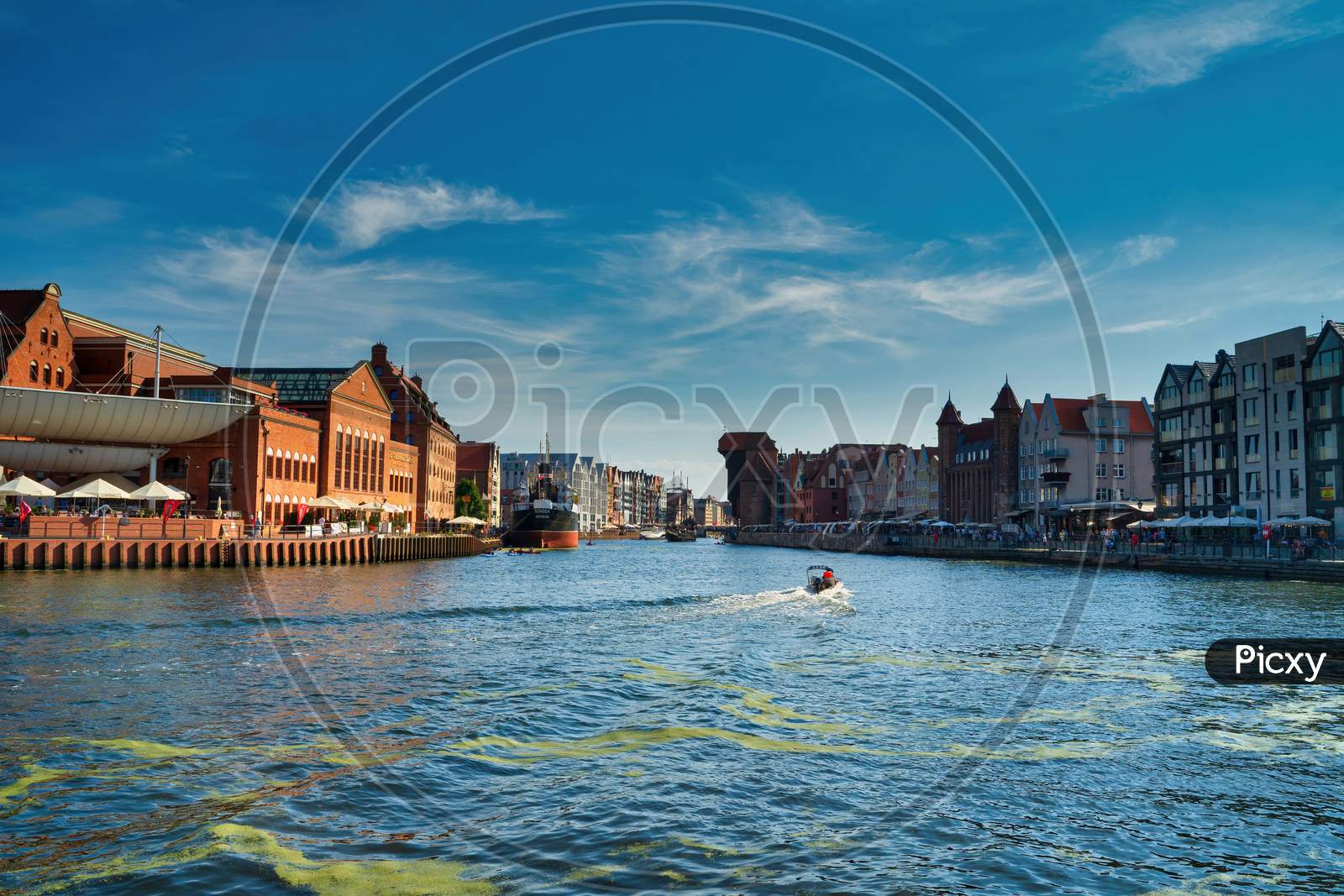 Gdansk, North Poland - August 13, 2020: Panoramic View Of Summer In Motlawa River Adjacent To Beautiful European Architecture Near Baltic Sea During Covid 19 Pandemic Against Blue Sky