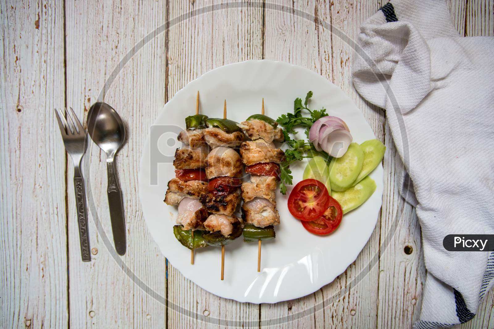 Grilled vegetables with chicken kebabs top view