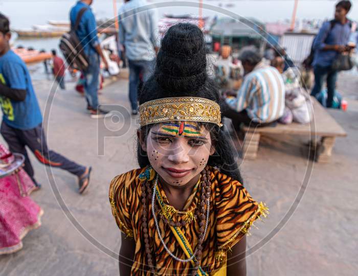 Portrait of a young boy dressed as lord shiva at varanasi ghat