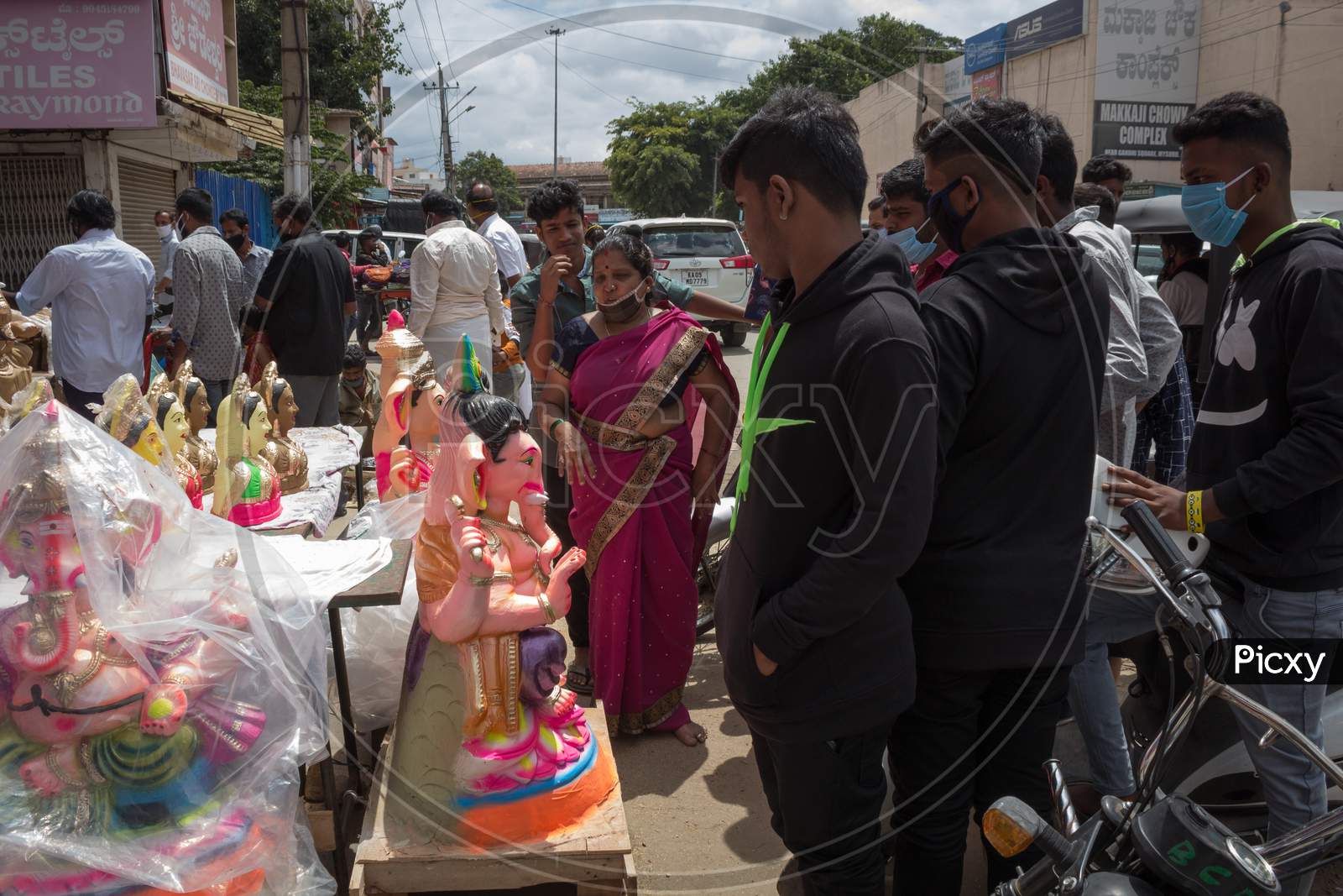 Youths having  a look at the Ganesha idols displayed in various Shapes and sizes at Mysuru/Karnataka/India.