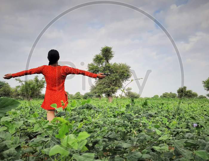 Asian Teenager Female Standing Wide Open Hands And Happy In Farms