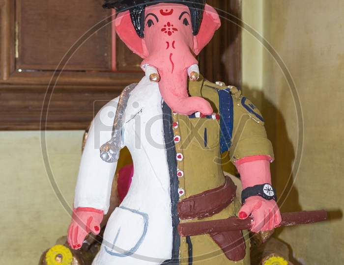 A Clay model of Ganesha in Corona Warrior clothing at Mysuru/Karnataka/India.