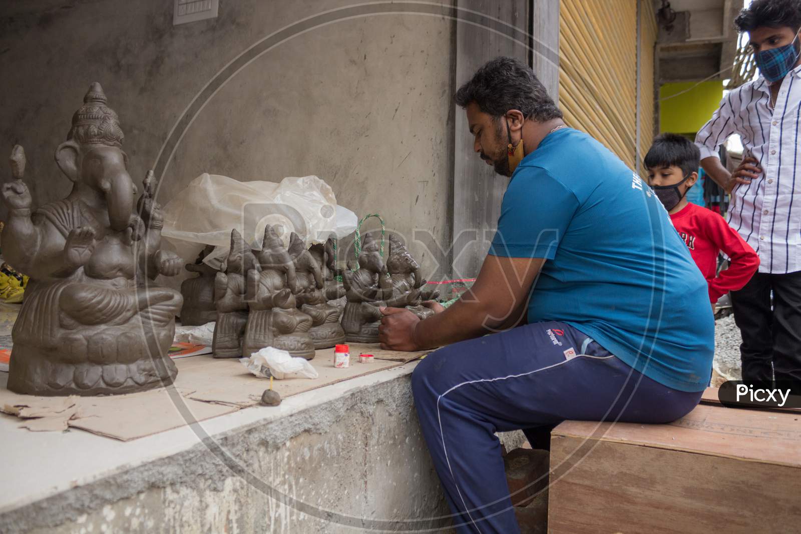 A Clay artist giving finishing touches to the Ganesha idol for the festival at Mysore/Karnataka/India.