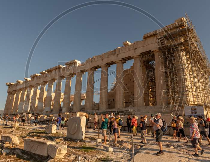 Athens, Greece - 13Th October, 2019: Tourists Admiring And Taking Pictures Of The Parthenon, While Walking Past It.