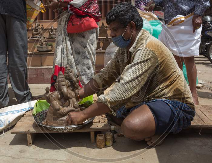A seller is preparing to deliver the Ganesha idol at Market place in Mysuru/Karnataka/India.