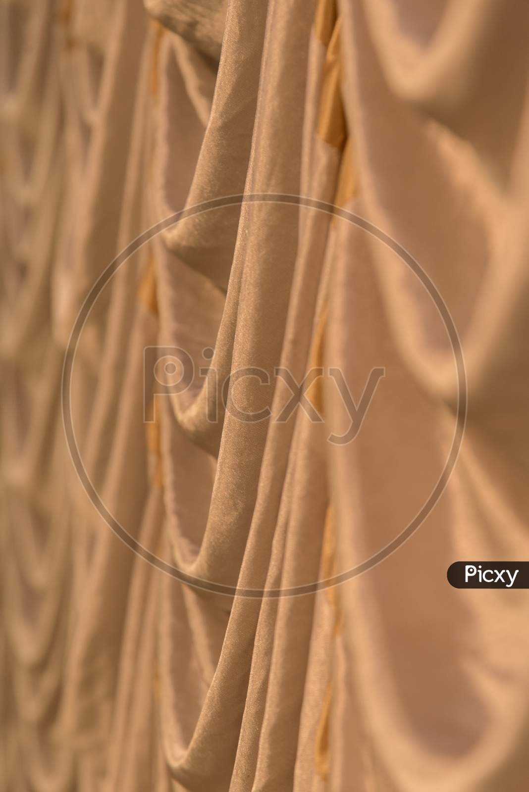 Silk Cloth Backdrop. Golden Silk Cloth With Wavy Pattern.