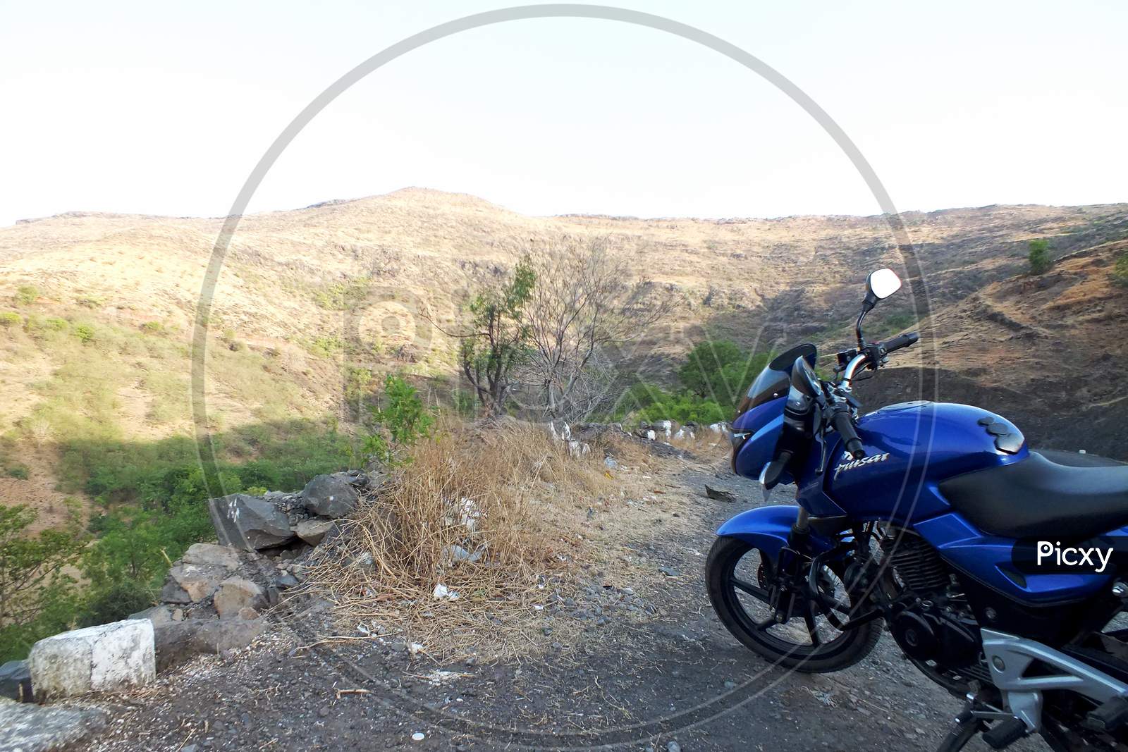 Mountains motorcycle travelling by a Pulsar