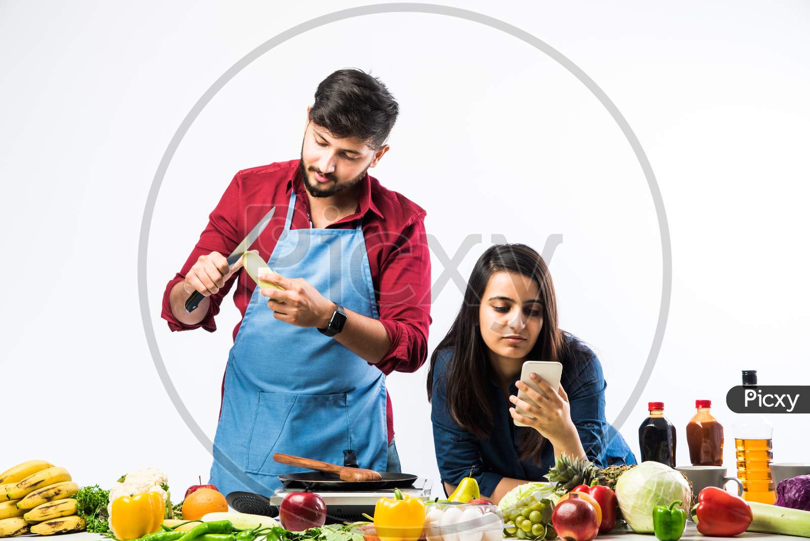 Indian Couple Cooking - Attractive Wife And Handsome Husband In Kitchen With Fresh Green Vegetables