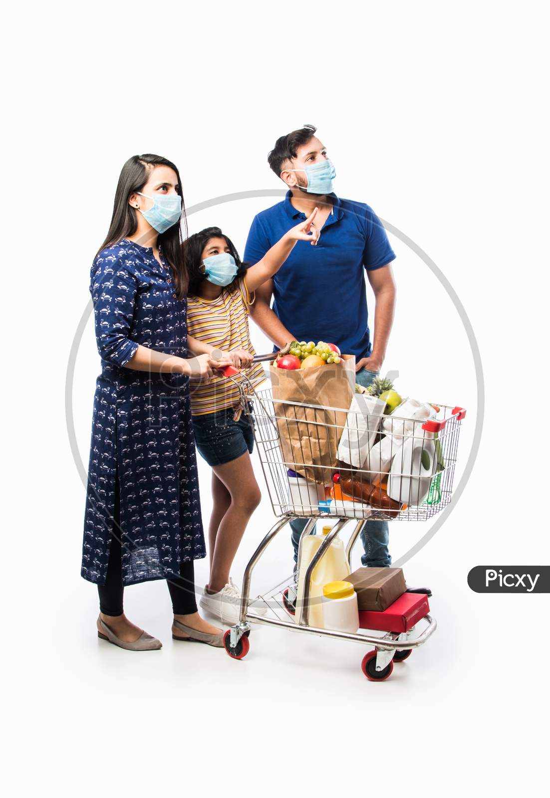 Indian Young Family Shopping Using Cart In Corona Or Covid-19 Pandemic Outbreak Wearing Mask