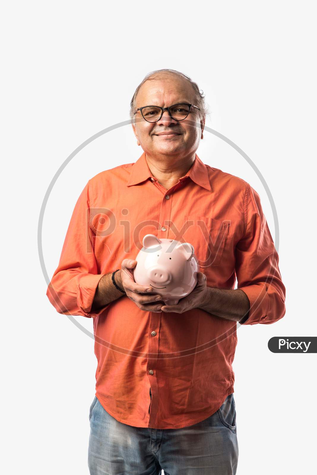 Indian Old Man Or Retired Senior Male Adult Holding Piggy Bank Or Money Box