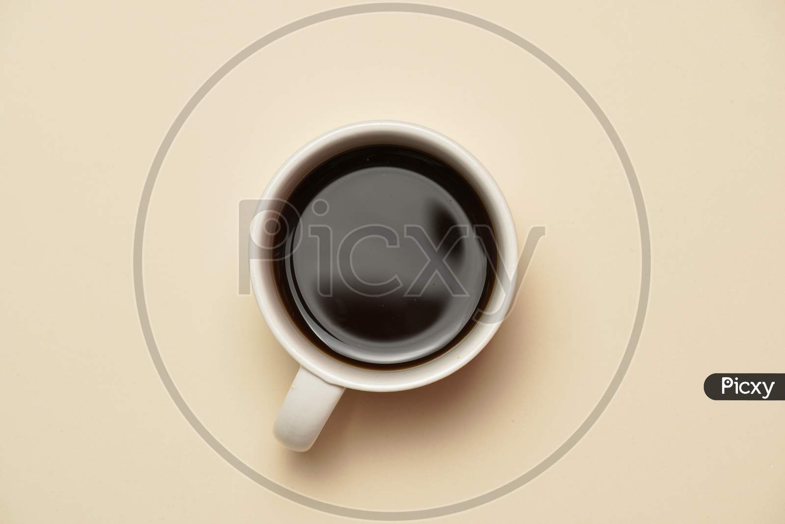 Top View Of Cup Of Coffee On Pale Orange Background. Flat Lay.
