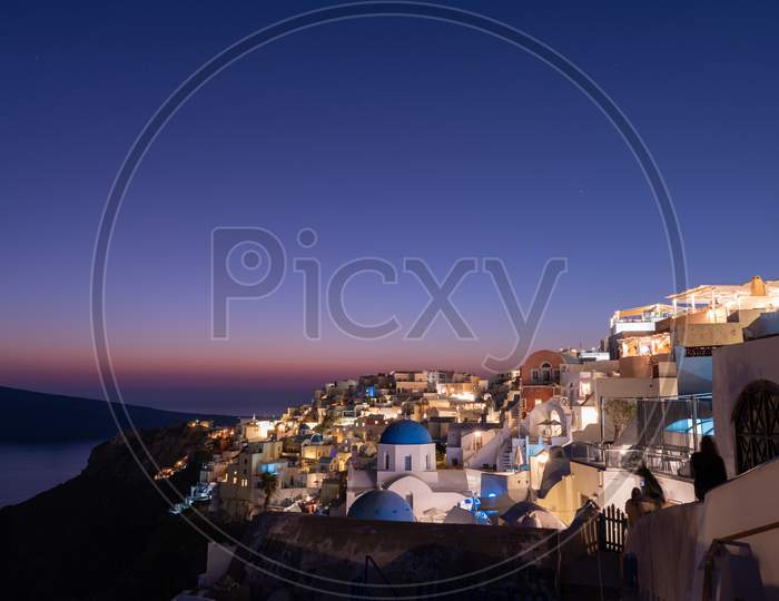 Colorful Village Of Oia On The Island Of Santorini, Greece After Sunset.