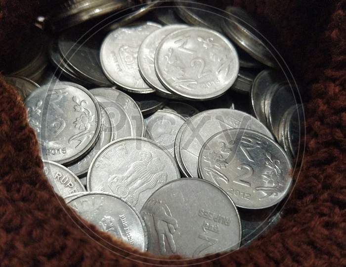 Indian coins in woolen bag.
