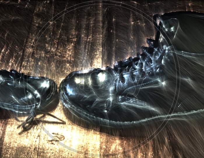 3D-Illustration Of Kirlian Energy On A Big And Small Black Leather Shoe On A Wooden Floor