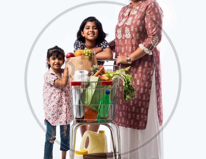 Indian Mom And Daughter Shopping With Trolly Or Cart