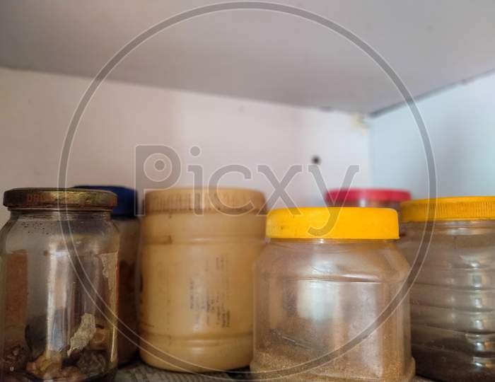 Arranged Jar Of Spices In The Kitchen Rack