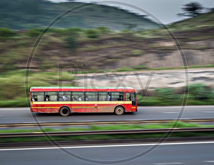 Red Colored Old Pune Municipal Transport Local Bus , Speeding On Highway.