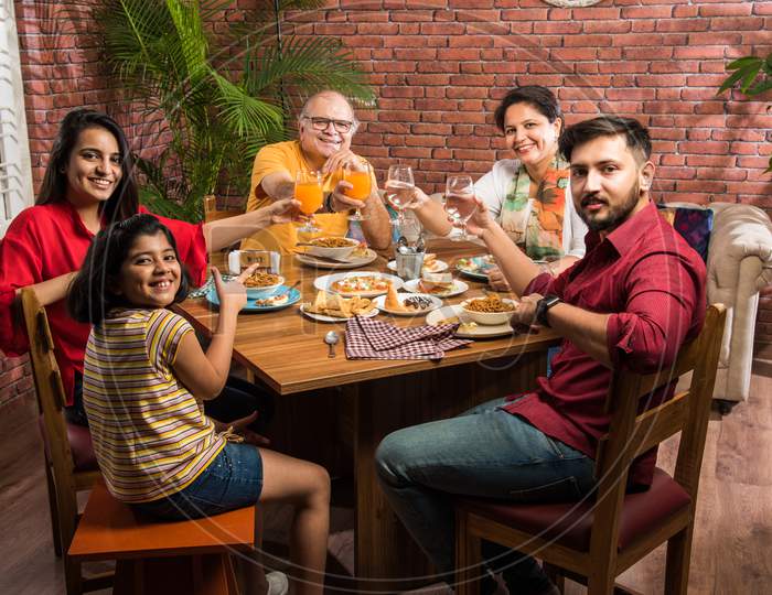 Indian family eating food at home or restaurant