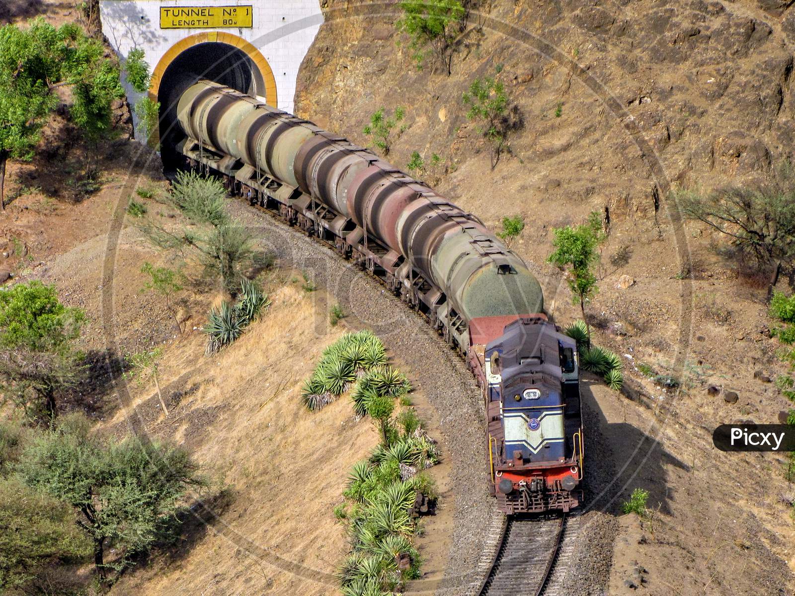 Diesel Locomotive Hauling A Tanker Rake Through A Tunnel On A Railway Line.