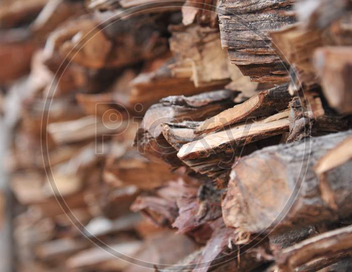 Wood logs stacked by pile closeup