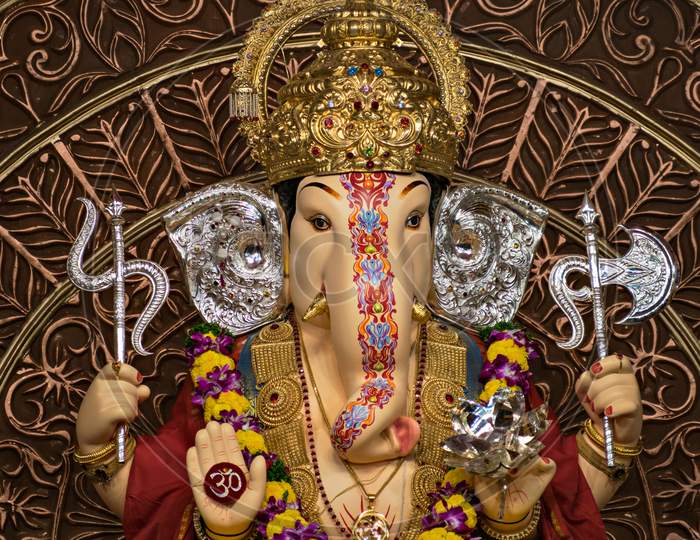 Close Up,Portrait View Of Decorated & Garlanded Isolated Idol Of Hindu God Ganesha.