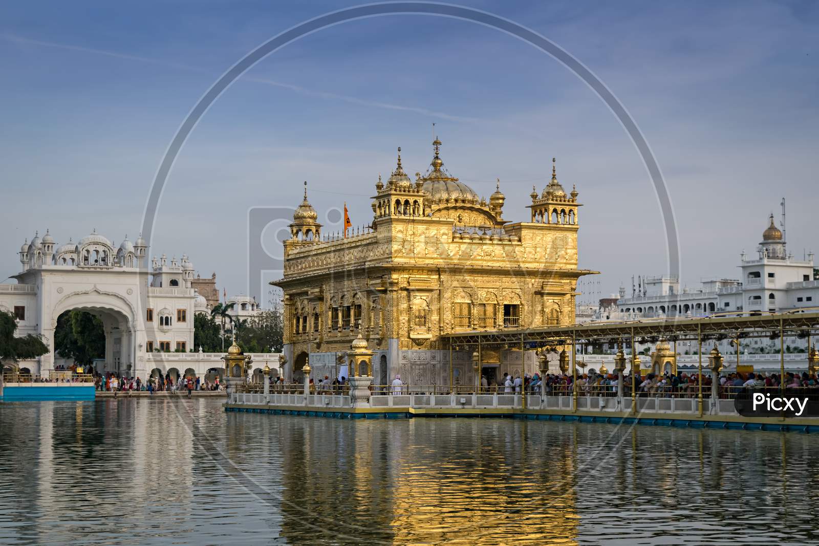 Evening View Of The Golden Temple In Amritsar, India With Beautiful Blue Sky.