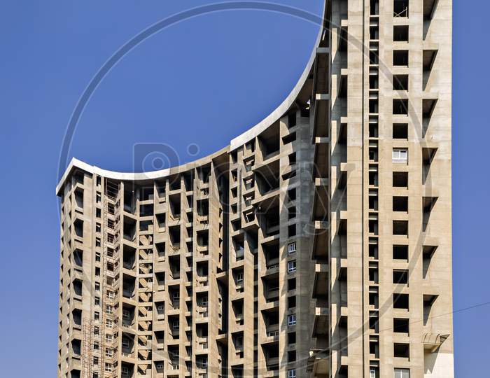 Tall Building Project , Under Construction On A Background Of Blue Sky.