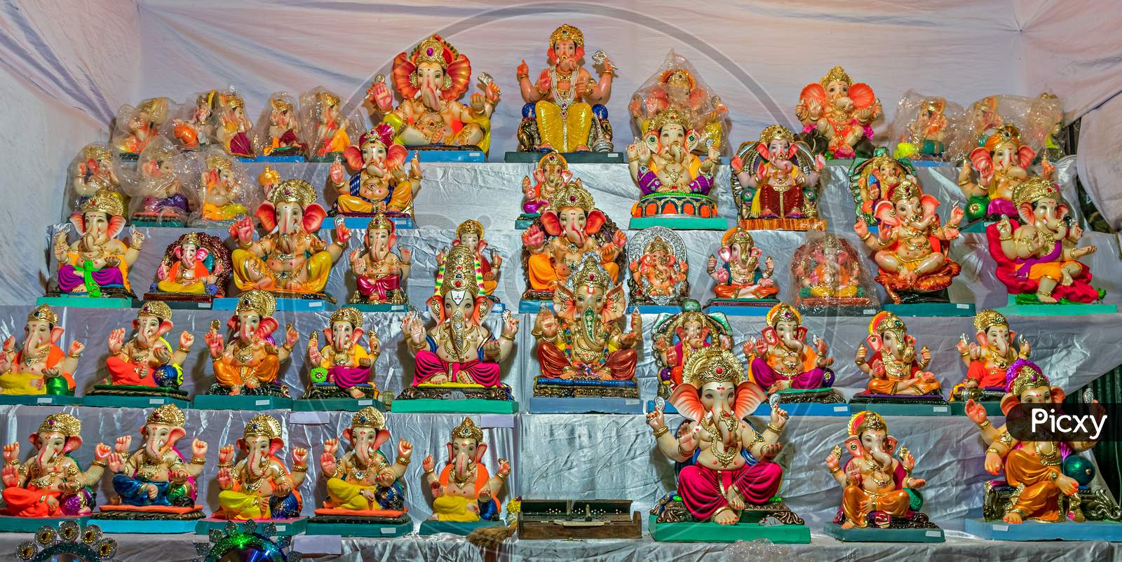 Colorful Clay Made Idols Of Hindu God Lord Ganesha Ready For Sale At A Stall.