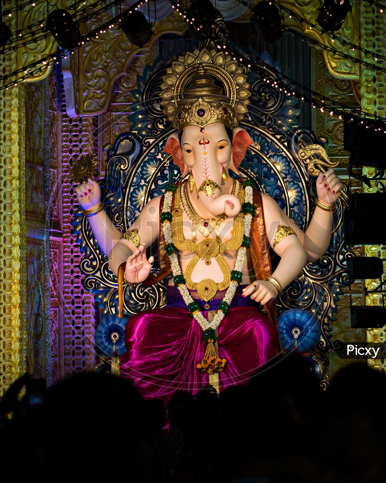 Closeup , Portrait View Of Decorated And Garlanded Idol Of Hindu God Ganesha.