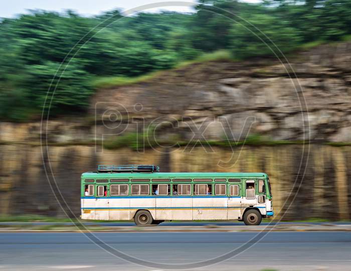 Isolated , Slow Shutter Speed Panning Image Of A Speeding Bus On Highway.