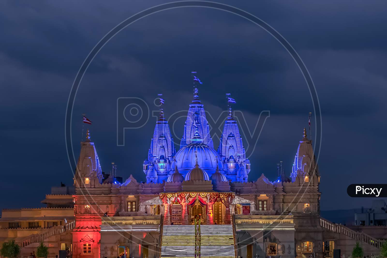 Lighted Image Of Shree Swaminarayan Temple With Monsoon Clouds Background, Pune.