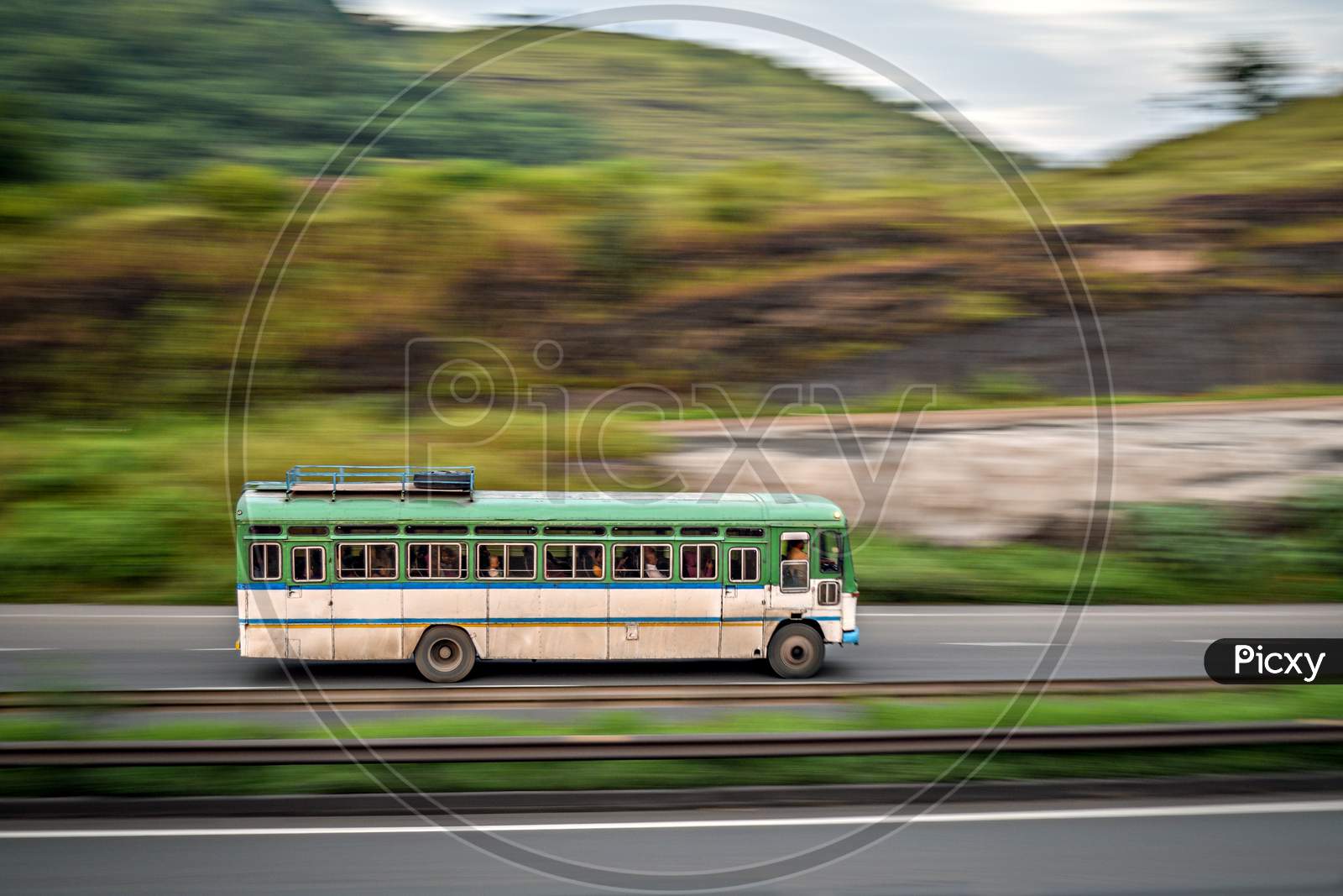 Isolated , Slow Shutter Speed Panning Image Of A Speeding Bus On Highway.