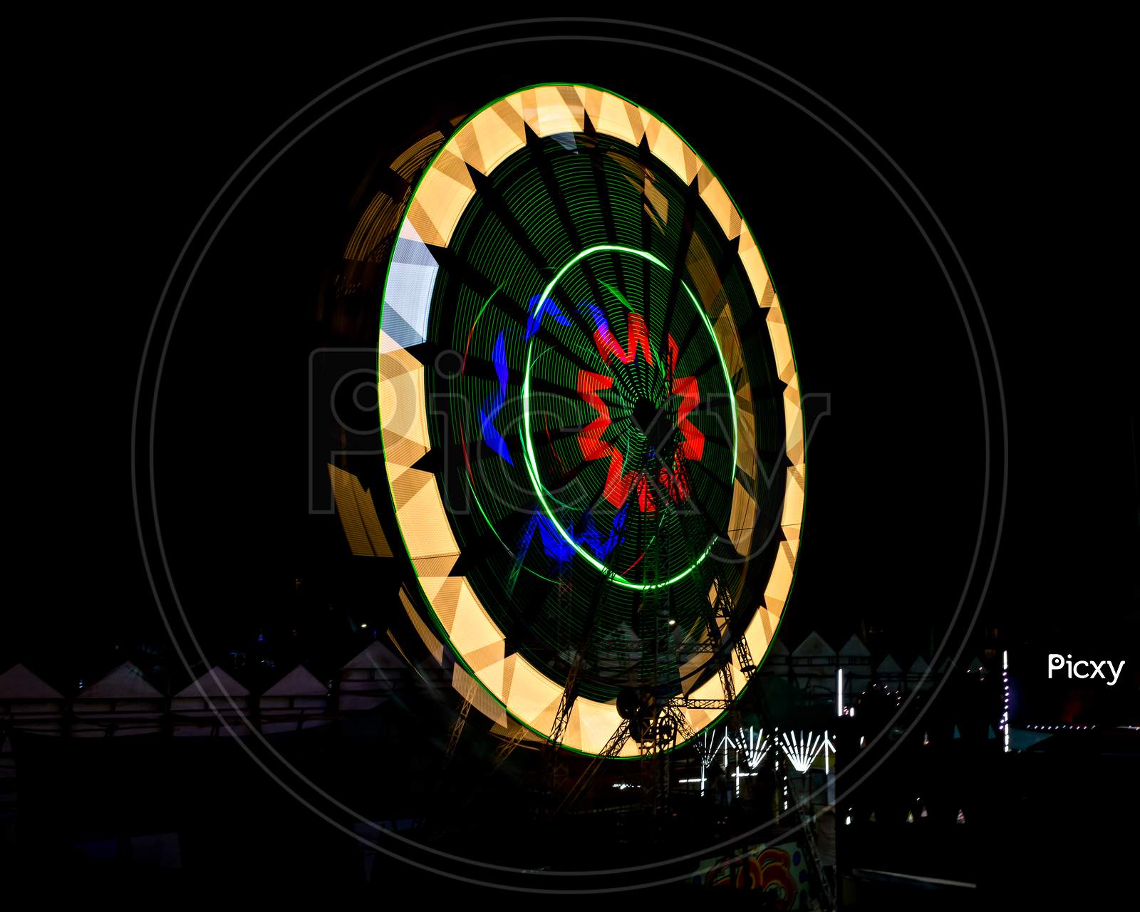 Slow Shutter, Night Image Of A Spinning Giant Wheel In Funfair In Pune, India.
