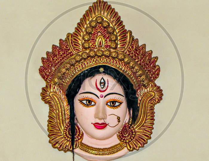 Precisely Crafted, Painted & Decorated Face Of Goddess Durga, Hanging On A Wall.