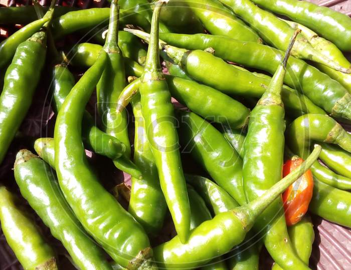 Fresh and green chillies in brown baskets