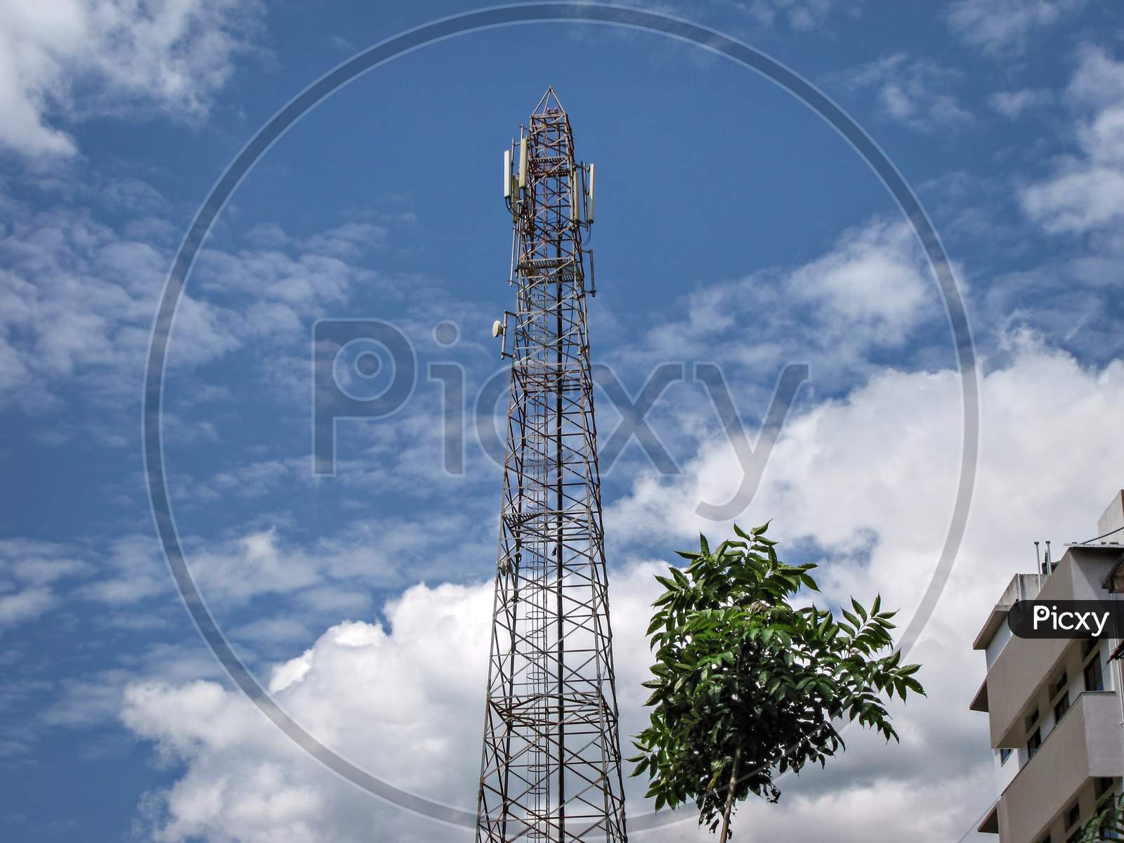 An Isolated Photo Of Cell Phone Mobile Tower On Background Of Nice Blue Sky.