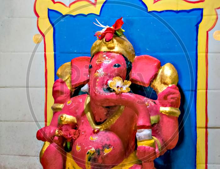 Close Up Image Of Red Colored Lord Ganesha Idol At A Temple In Velneshwar.
