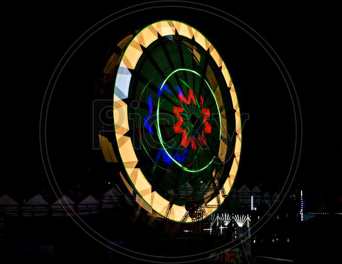 Slow Shutter, Night Image Of A Spinning Giant Wheel In Funfair In Pune, India.